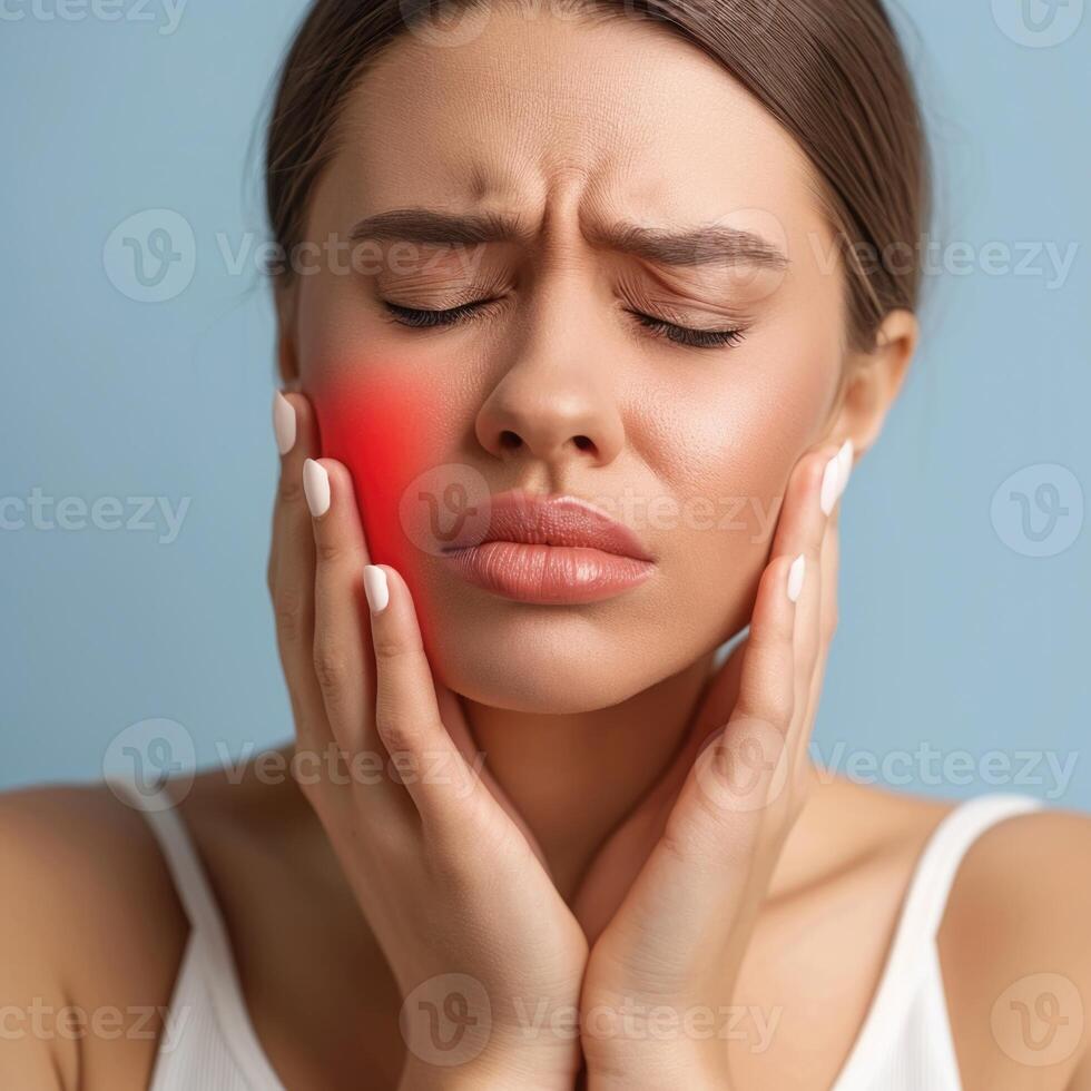 A woman holds her cheek while suffering from a toothache, depicting the discomfort and pain experienced during dental issues, emphasizing the need for oral health care and treatment photo