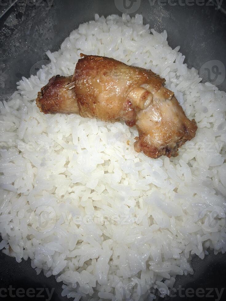 A piece of chicken neck and fragrant rice in a box photo