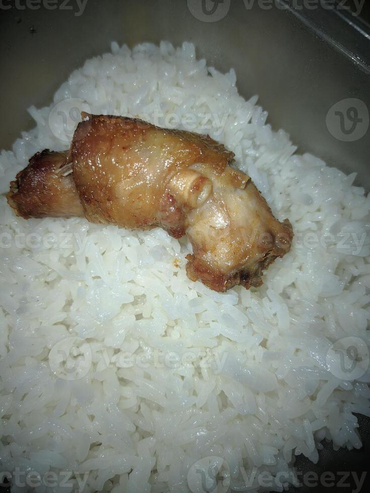 A piece of chicken neck and fragrant rice in a box photo