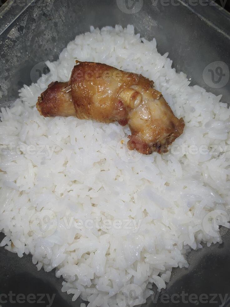 A piece of chicken neck and fragrant rice in a box photo
