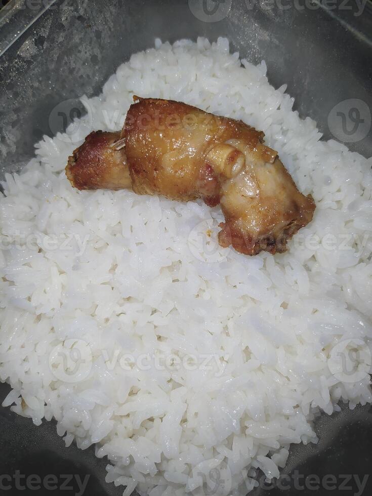 A piece of chicken neck and fragrant rice in a box photo