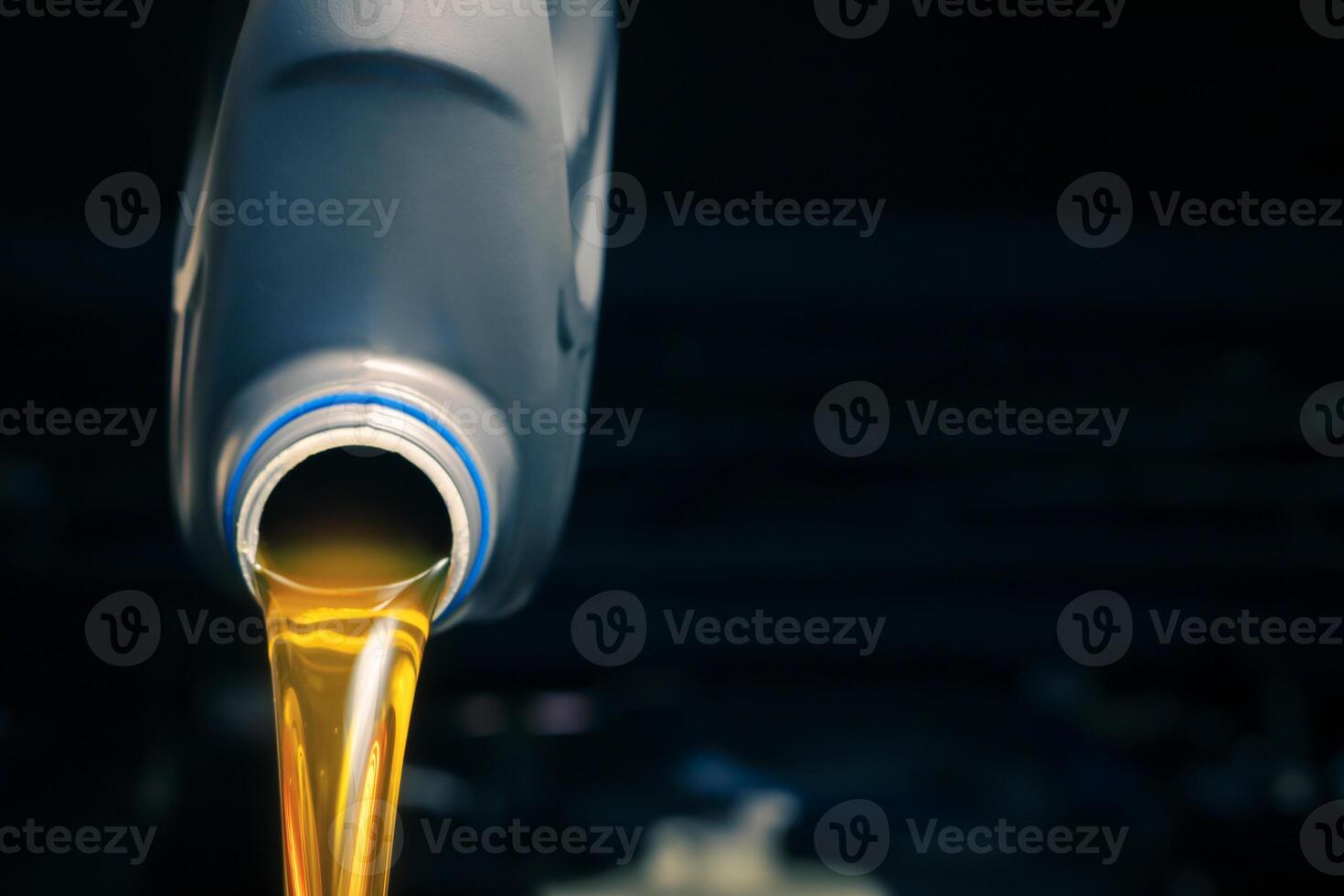 Pour engine oil from the lubricant bottle. Engine background, oil change shop engine service industry photo