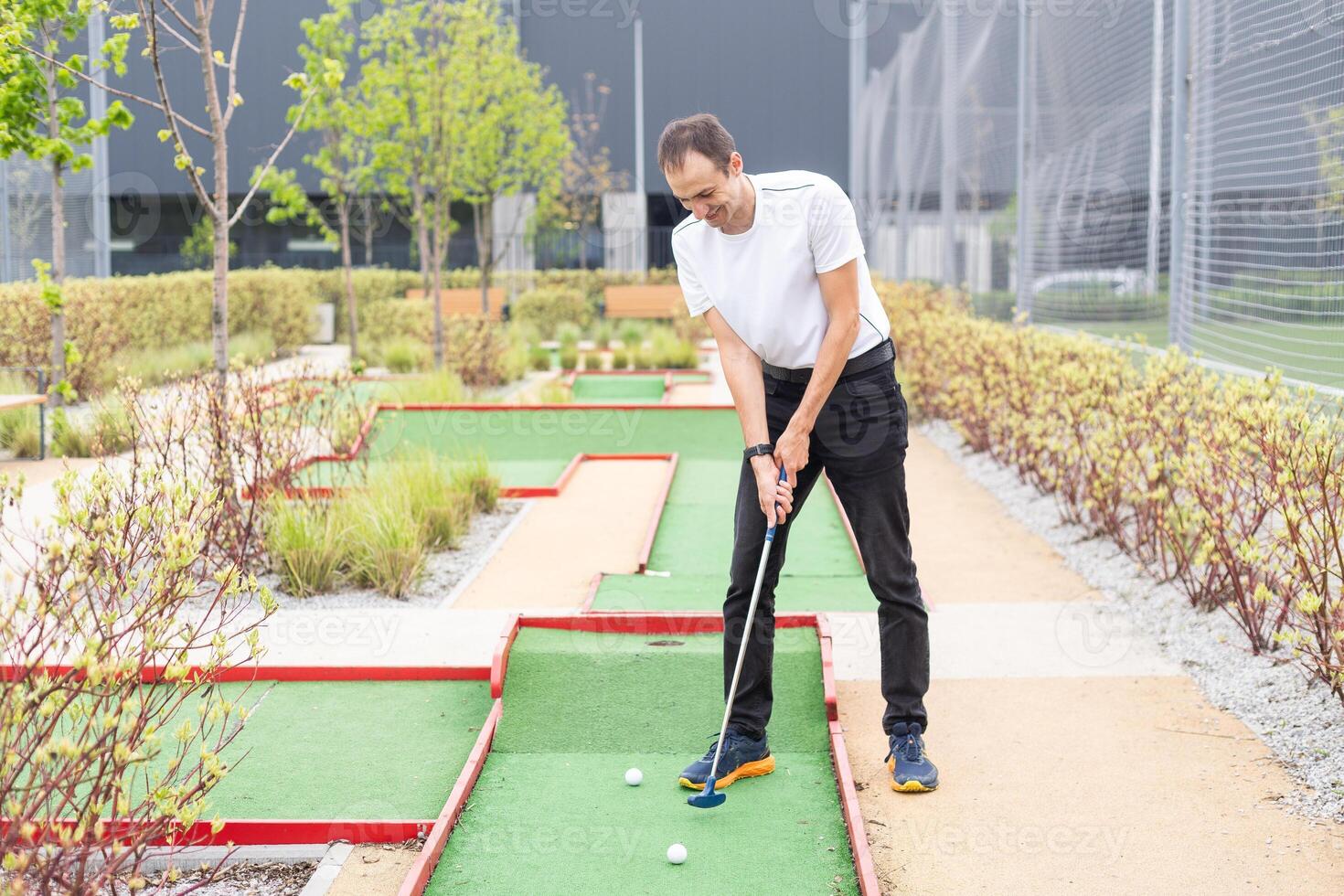 Minigolf player detail on green grass photo
