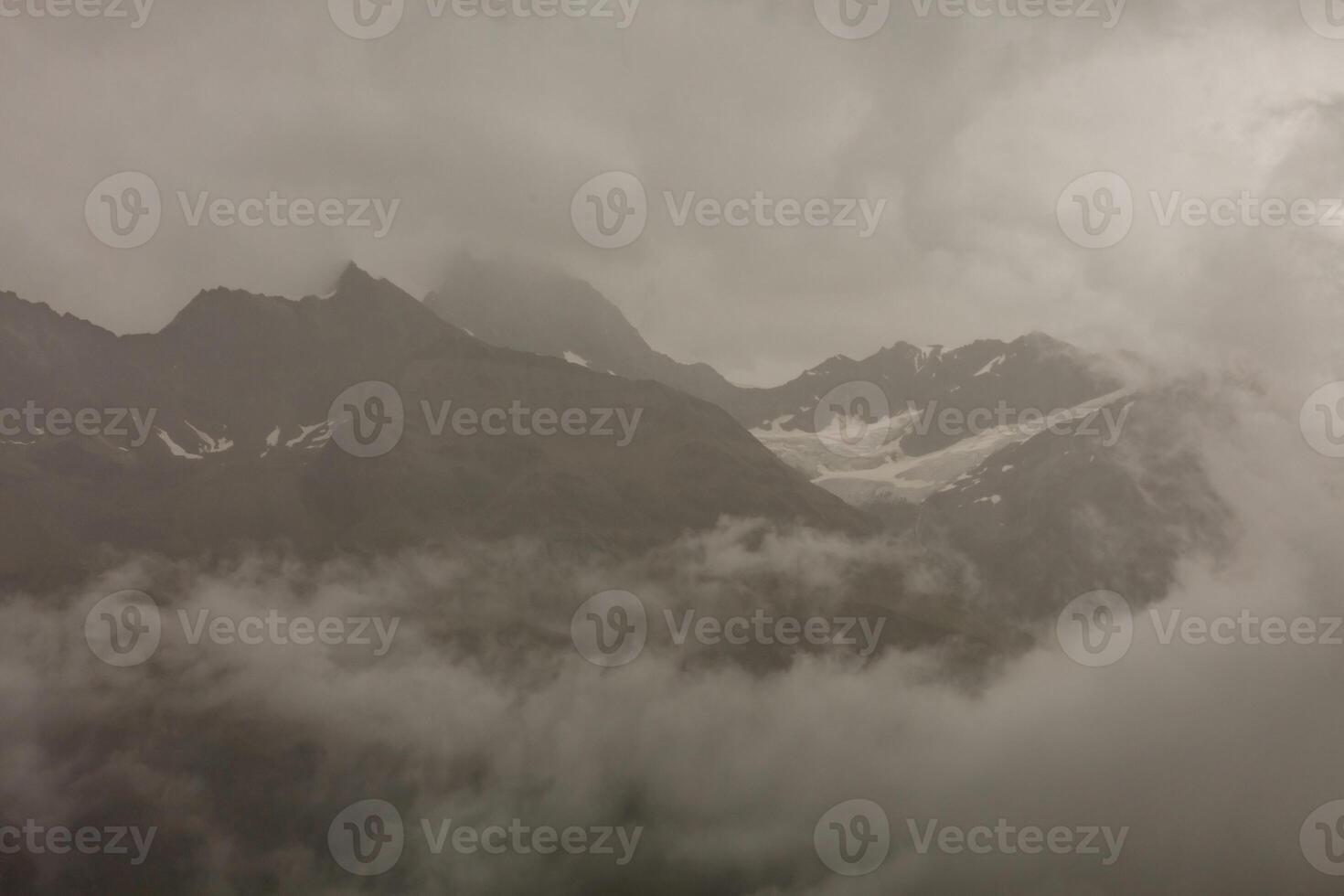 Panorama of cloud layer from mountain top over Swiss alps photo