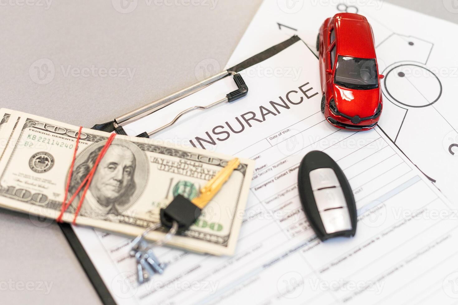 Top view of car insurance claim form with car key and car toy on desk photo