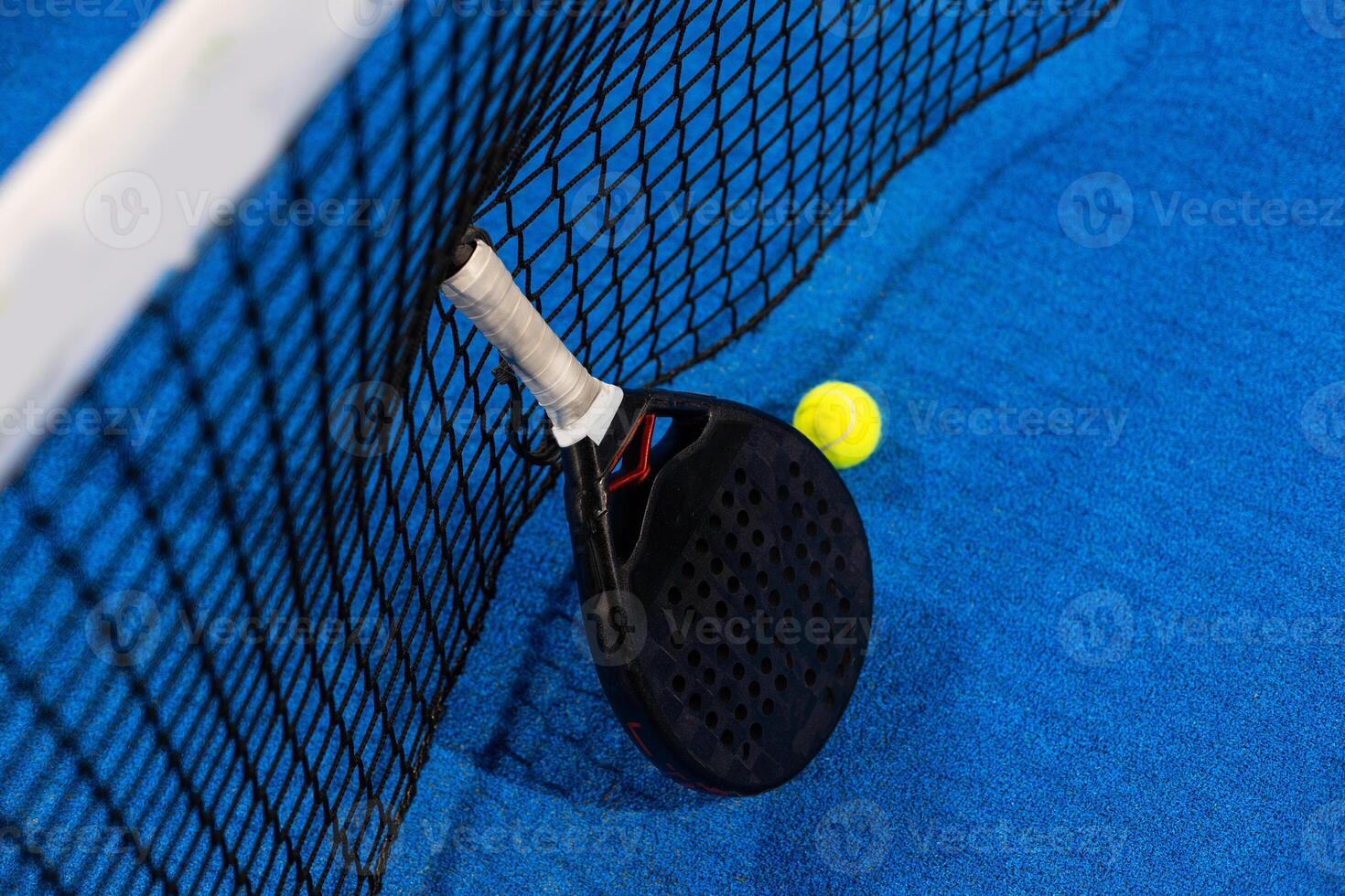 professional paddle tennis racket with natural lighting on blue background. Horizontal sport theme poster, greeting cards, headers, website and app photo