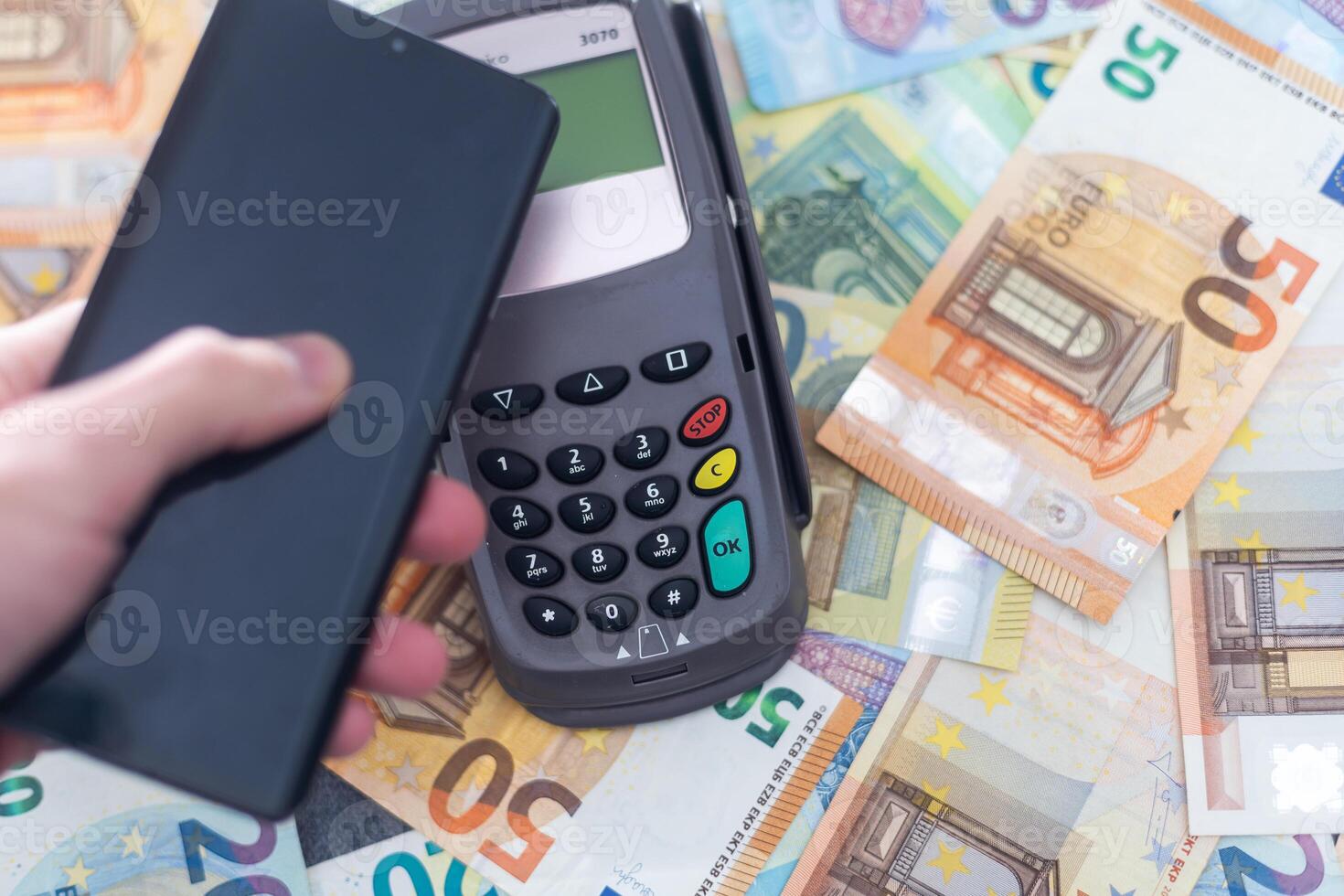 Banking terminal on euro banknotes background close up photo