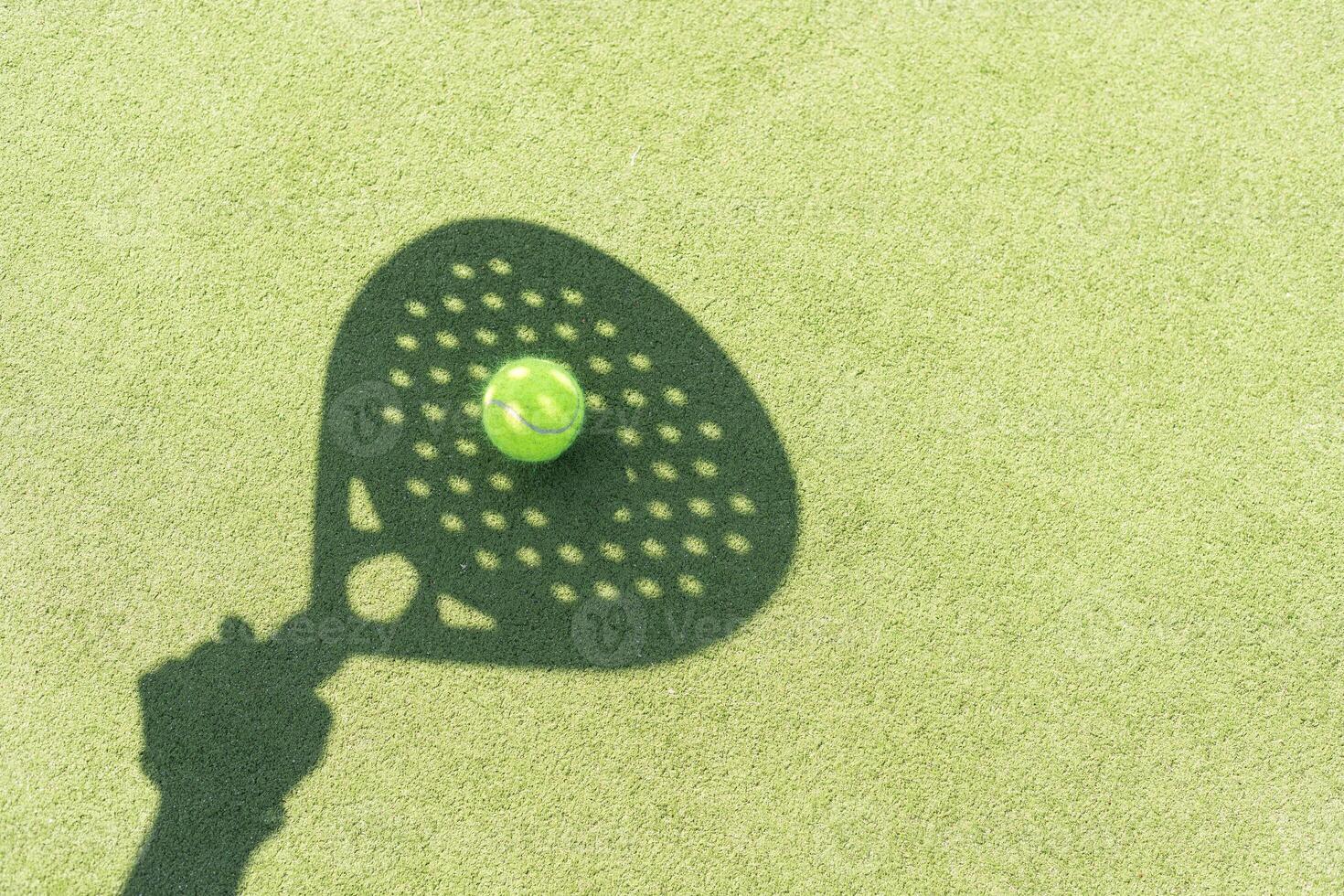 Paddle tennis racket shadow on balls. photo