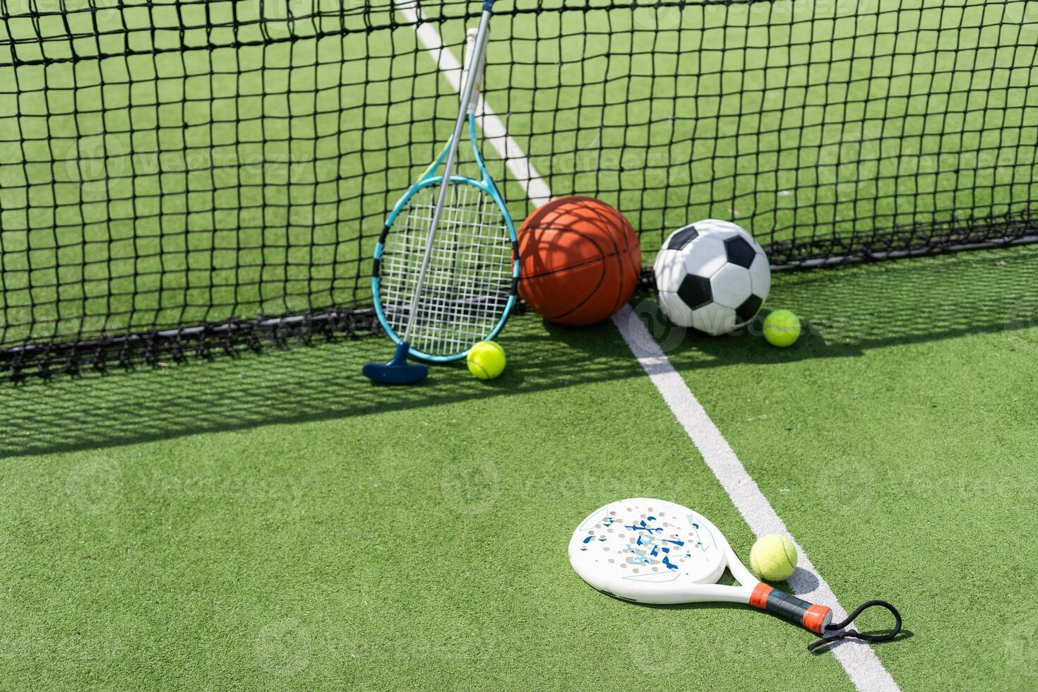 Set of sport equipment on green grass photo