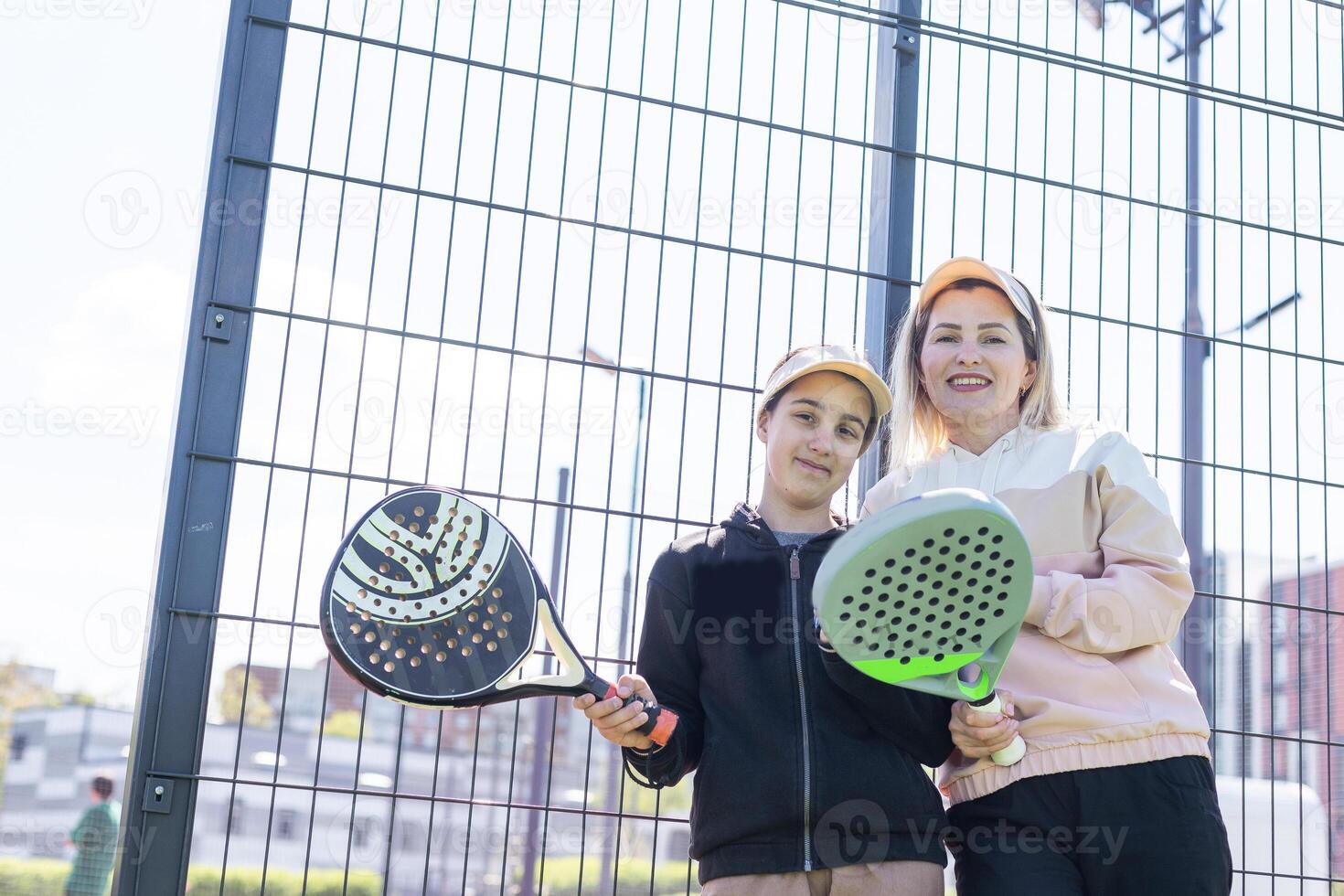 mother and daughter playing padel outdoor photo