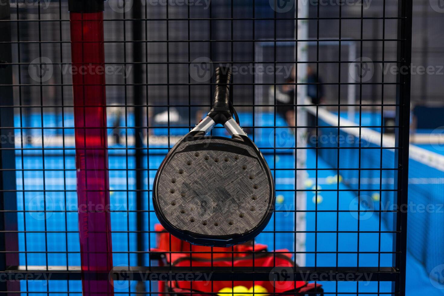 Black professional paddle tennis racket and ball with natural lighting on blue background. Horizontal sport theme poster, greeting cards, headers, website and app photo