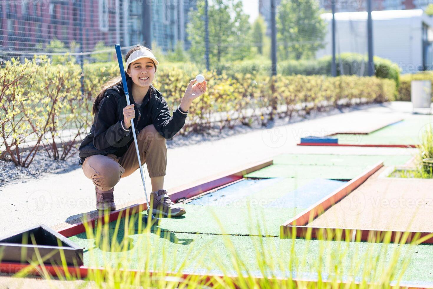 Mini-golf ball on artificial grass. Summer season game photo