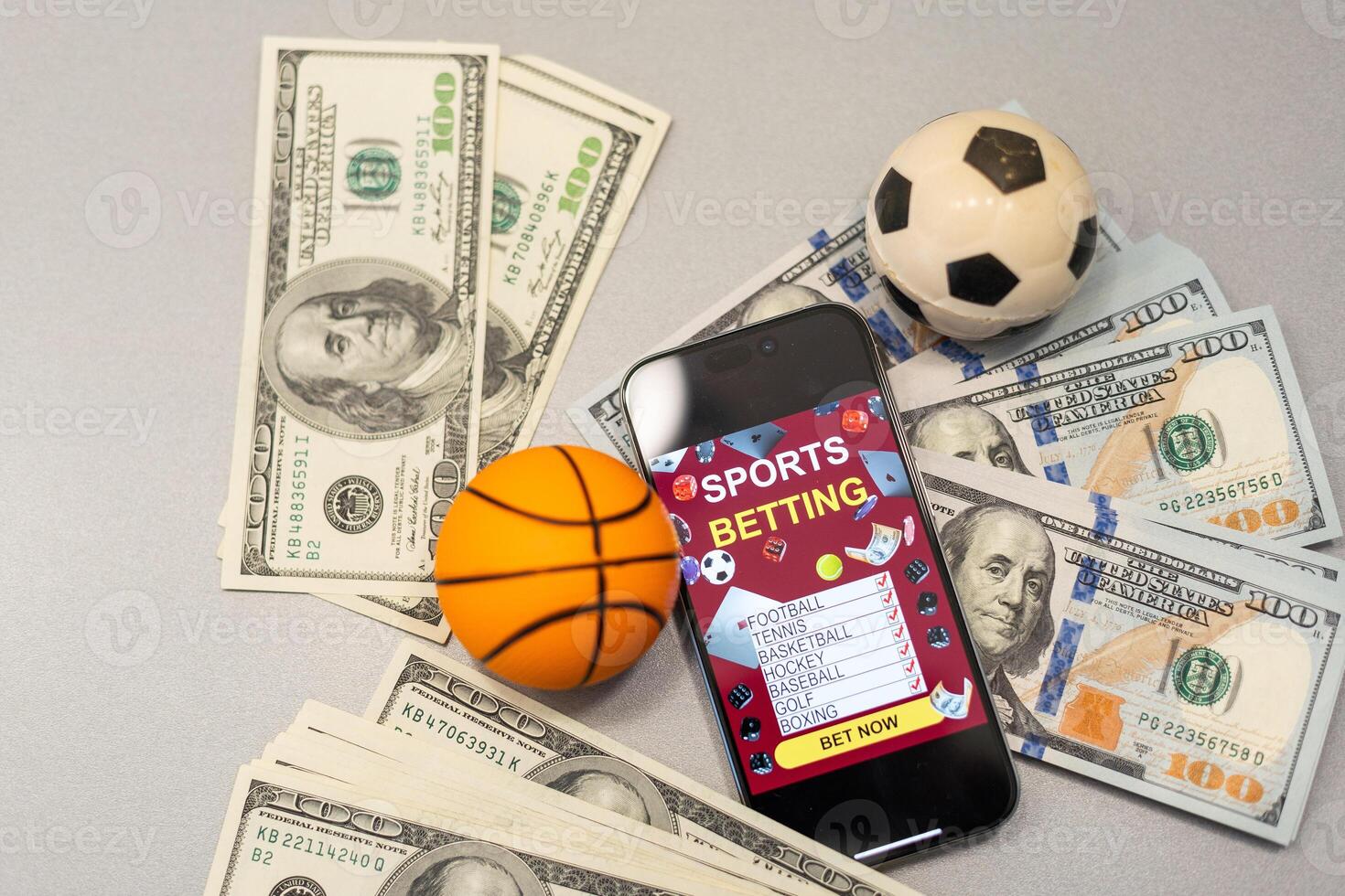 Basketball ball, smartphone with application and banknote of 100 dollars. Betting photo