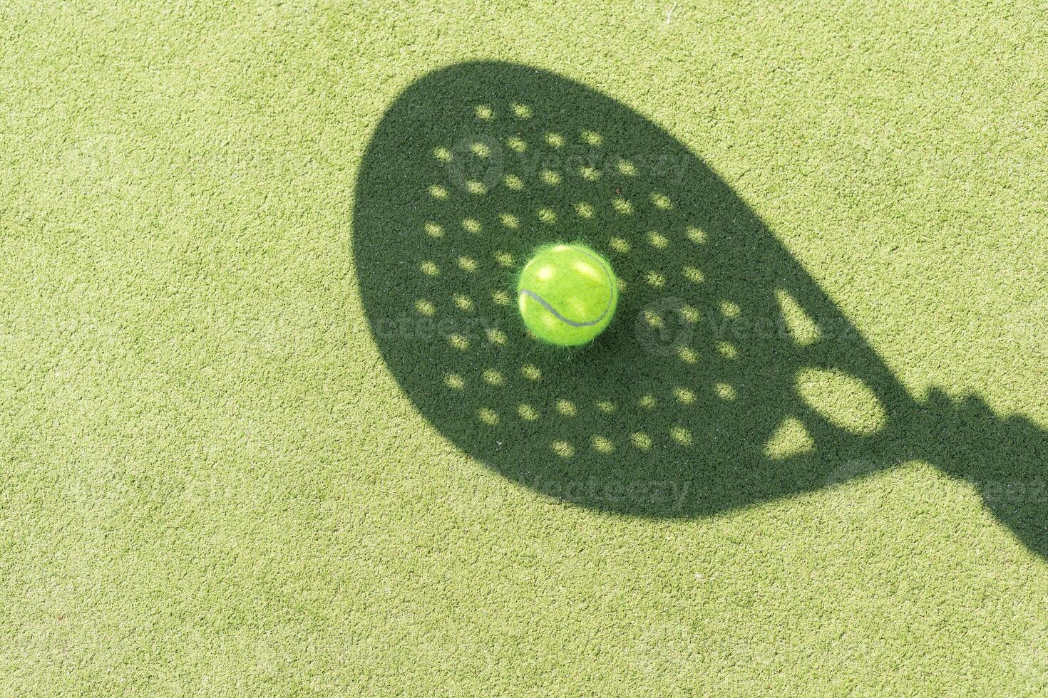 Paddle tennis racket shadow on balls. photo