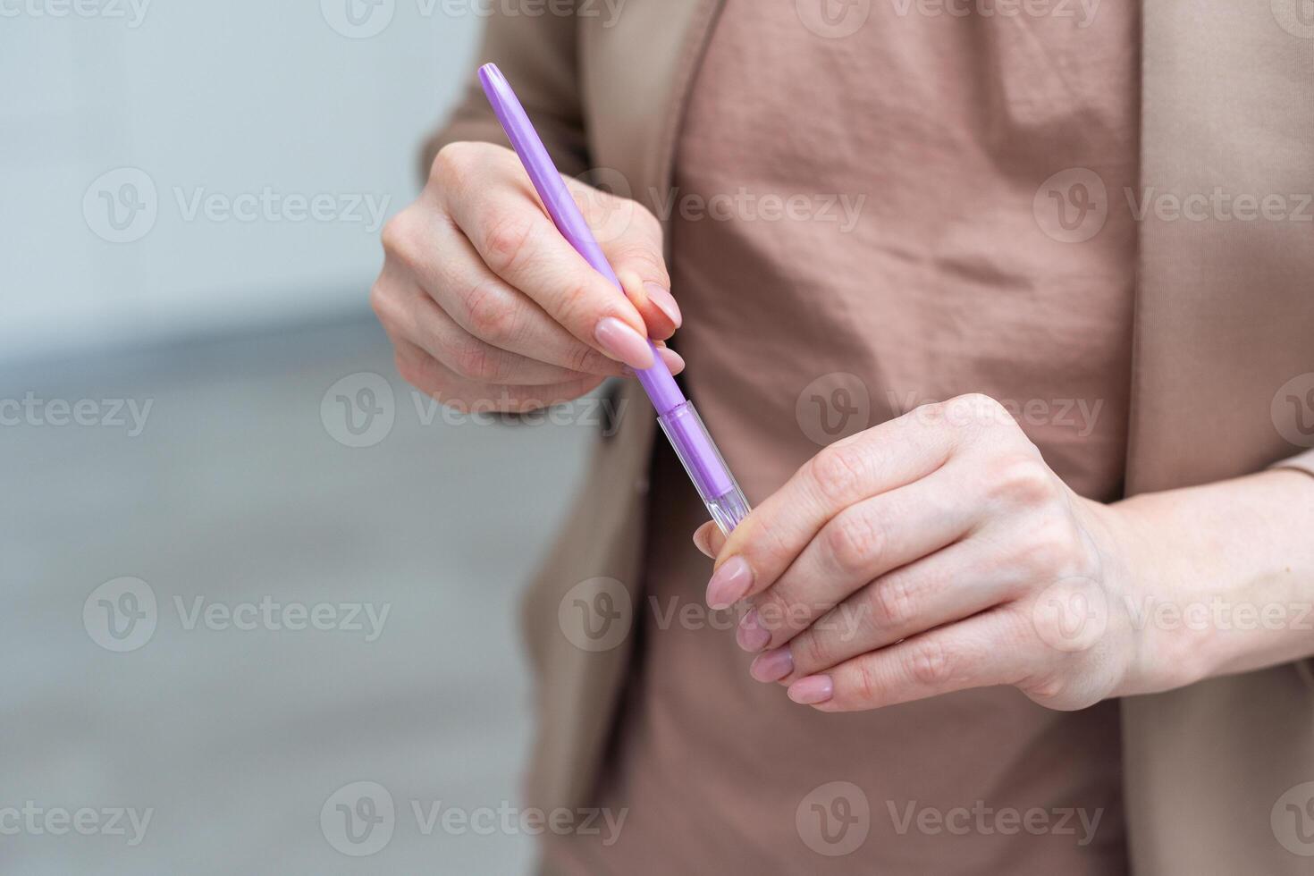 Using a hand hold the pen for writing. photo