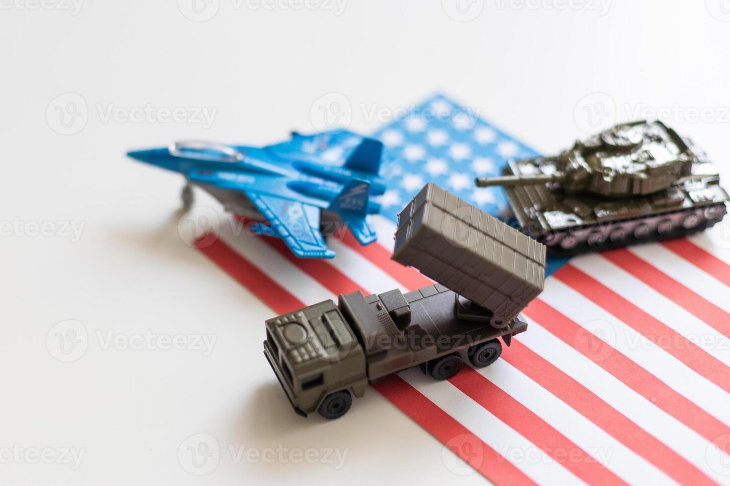 Miniature toy soldiers in battle scene with american flag background , Memorial Day concept photo