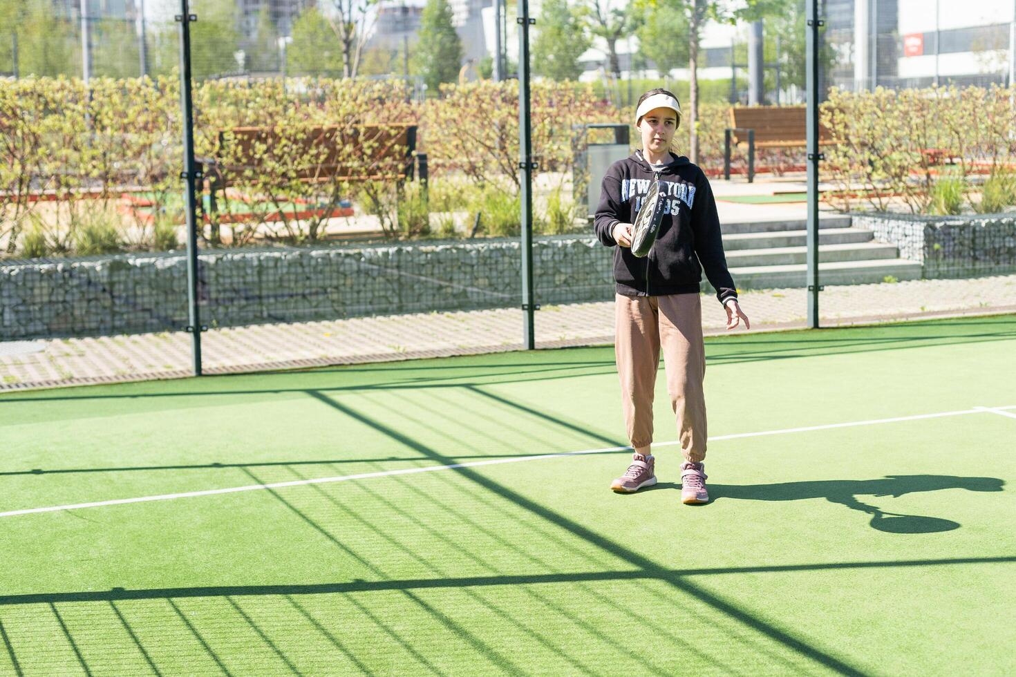 Ukraine Kyiv, April 20 2024. happy pretty girl practicing paddle sport on the paddle court photo