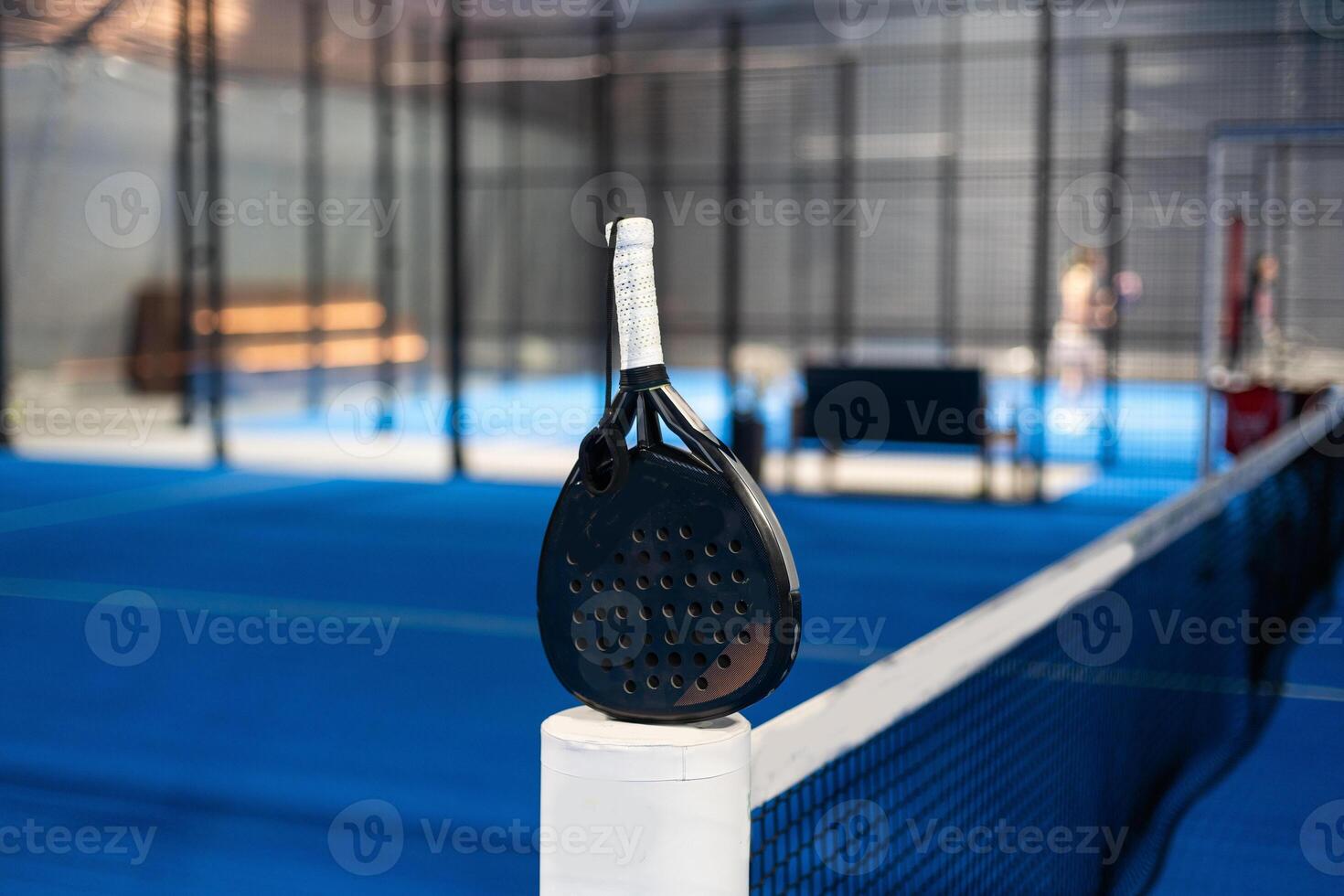 rackets and paddle balls on a court ready to play photo