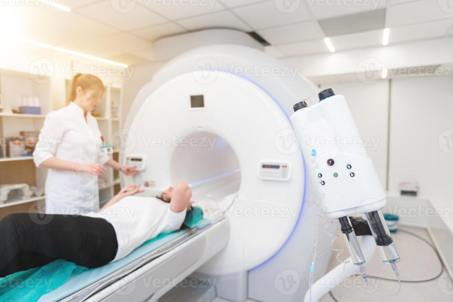 Female patient undergoing MRI - Magnetic resonance imaging in Hospital. Medical Equipment and Health Care photo