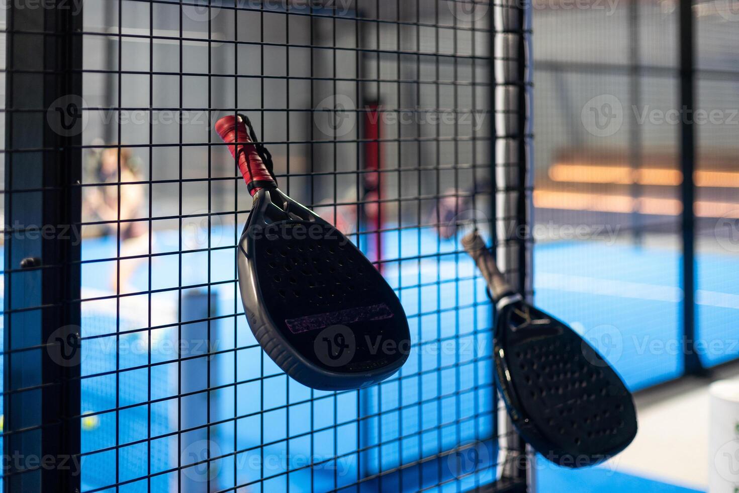 Paddle tennis. Padel racket and ball in front of an outdoor court. photo