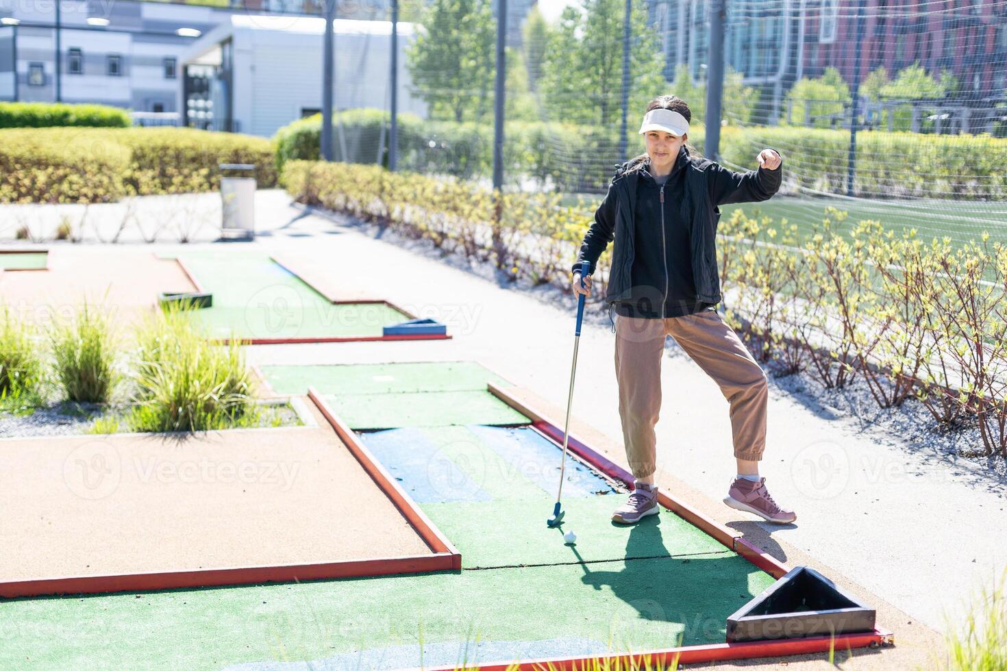 cute little girl on a miniature golf course. photo