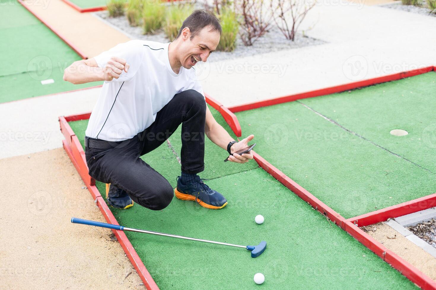 player looks at his hit on a mini golf course photo