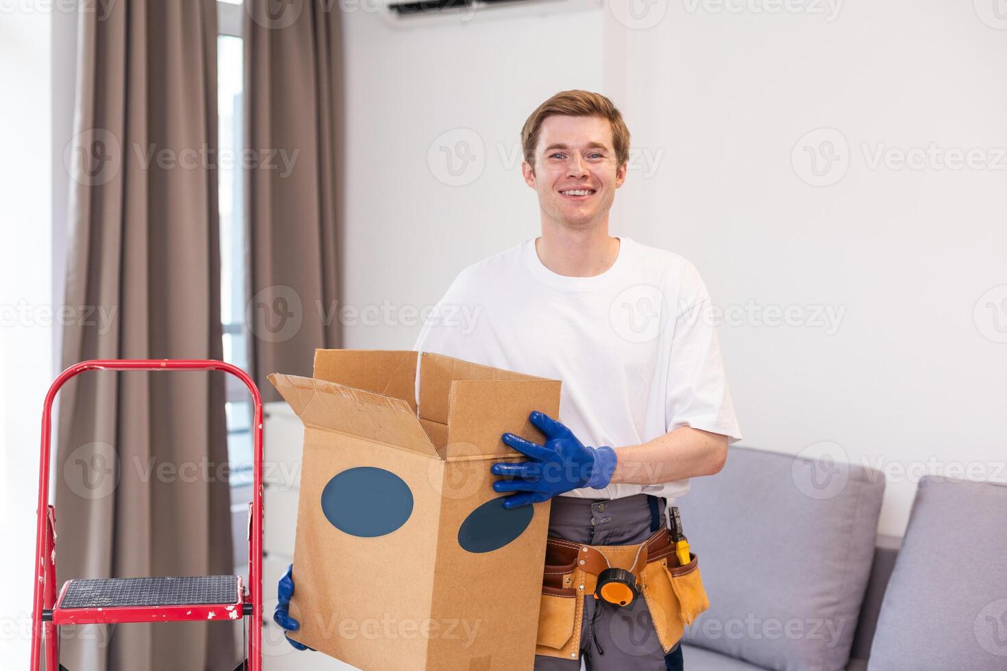 moving, people and real estate concept - happy smiling man holding boxes with stuff at new home photo