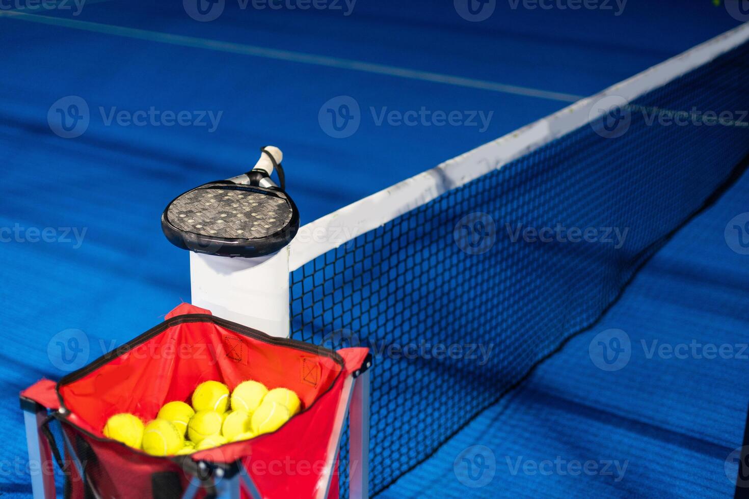 Paddle ball on racket. Yellow paddle ball laying near racket, photo