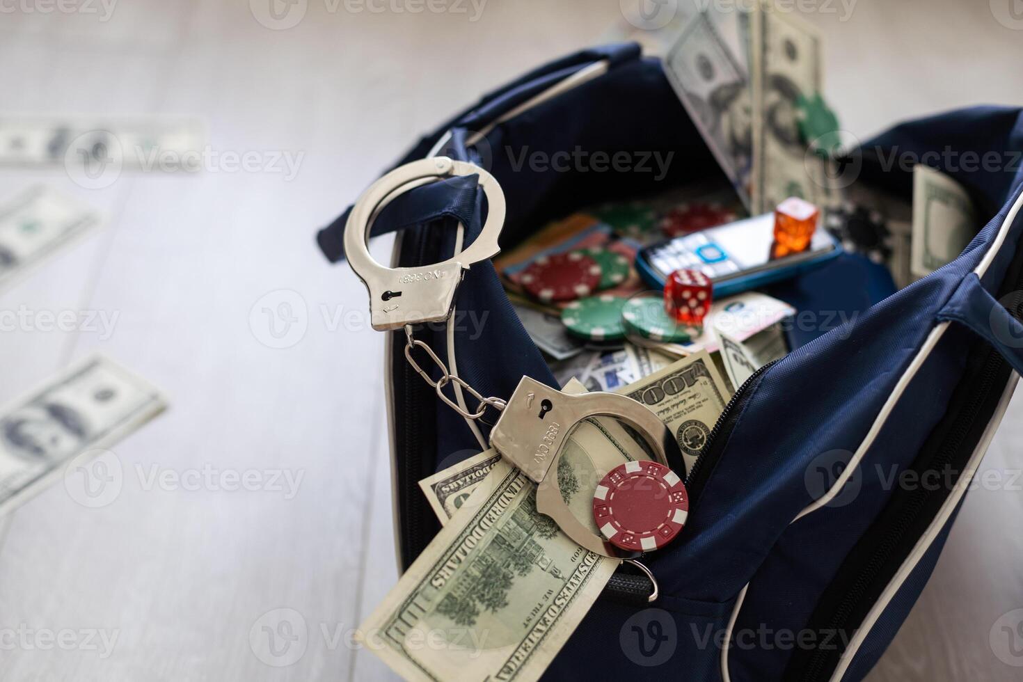 Handcuffs on many stacks of dollar bills. Metal suitcase with money, concept of arrest, investigation and fraud. photo