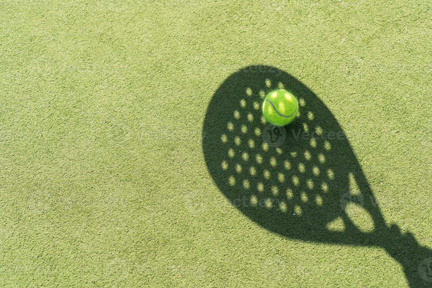 Paddle tennis racket shadow on balls. photo