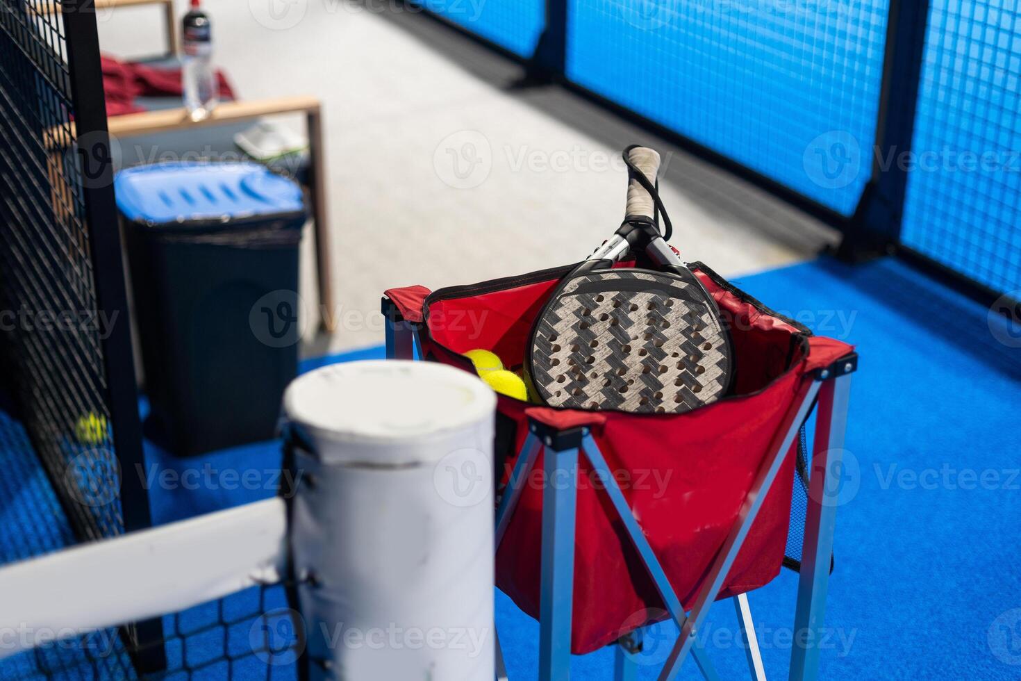 Paddle ball on racket. Yellow paddle ball laying near racket, photo