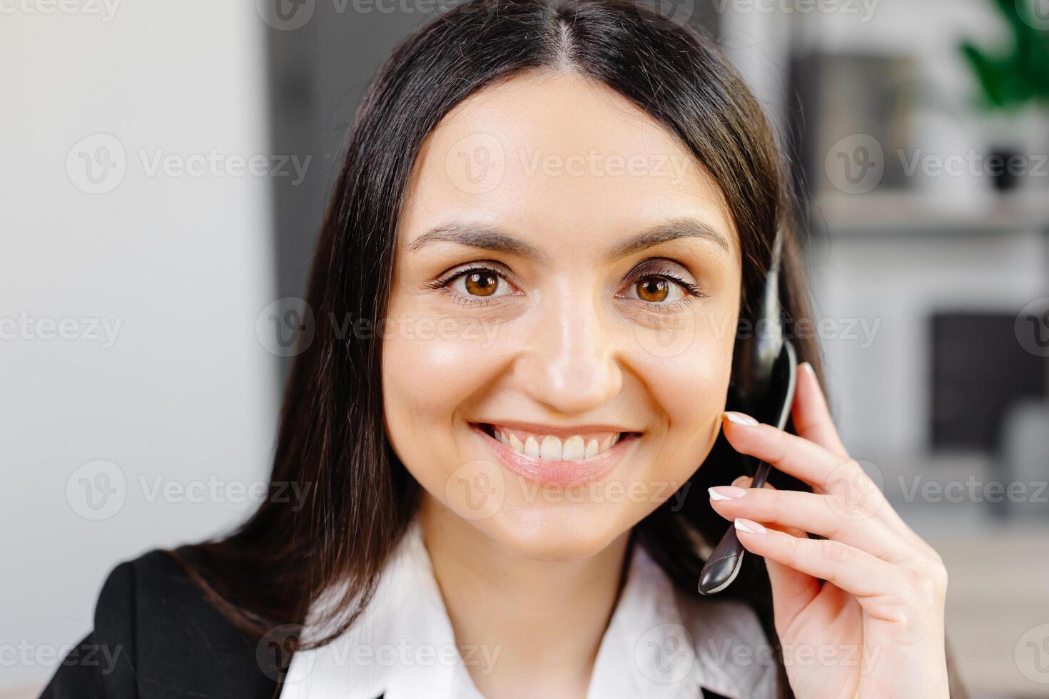 Call center agent with headset working on support hotline in modern office. conference. photo