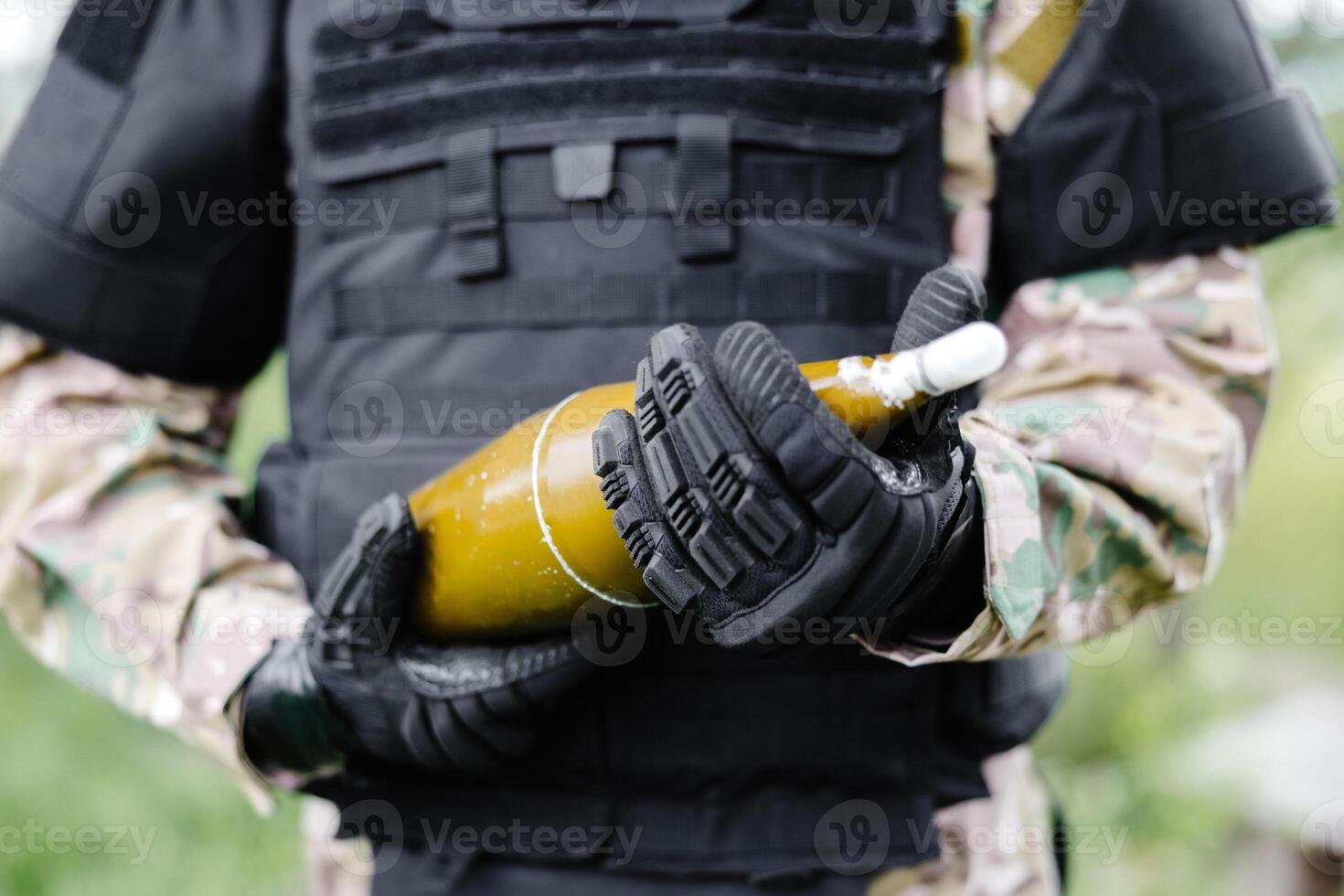 A man in a special suit works with a detector and found an explosive device photo