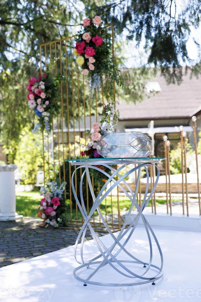 Glass top table with flowers in wedding photo