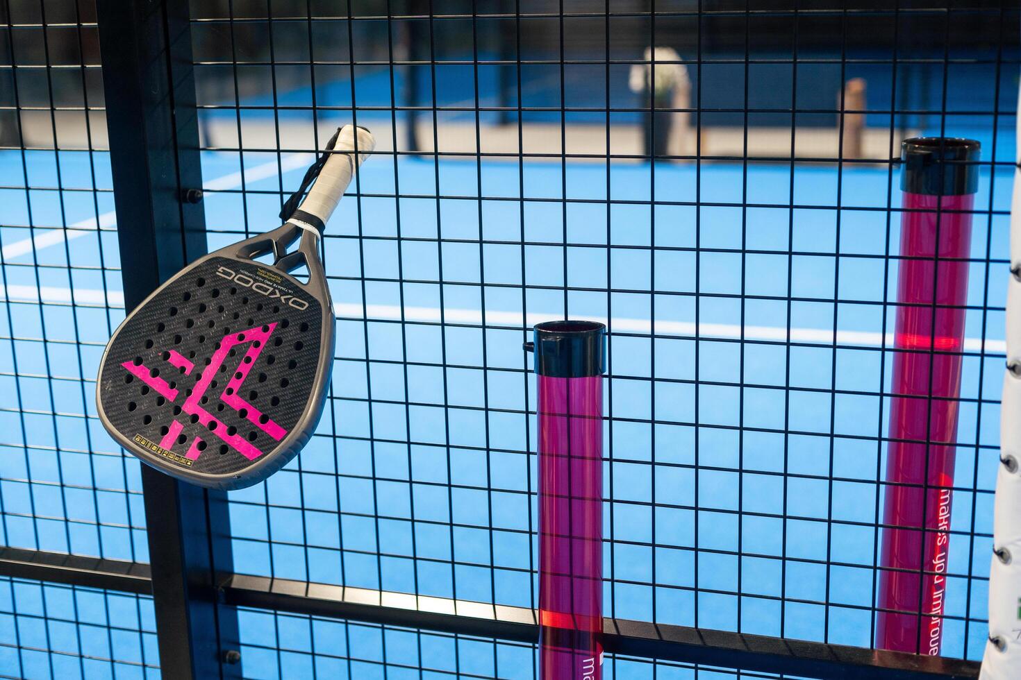Ukraine Kyiv, April 02 2024. paddle tennis racket and balls on the blue paddle court photo