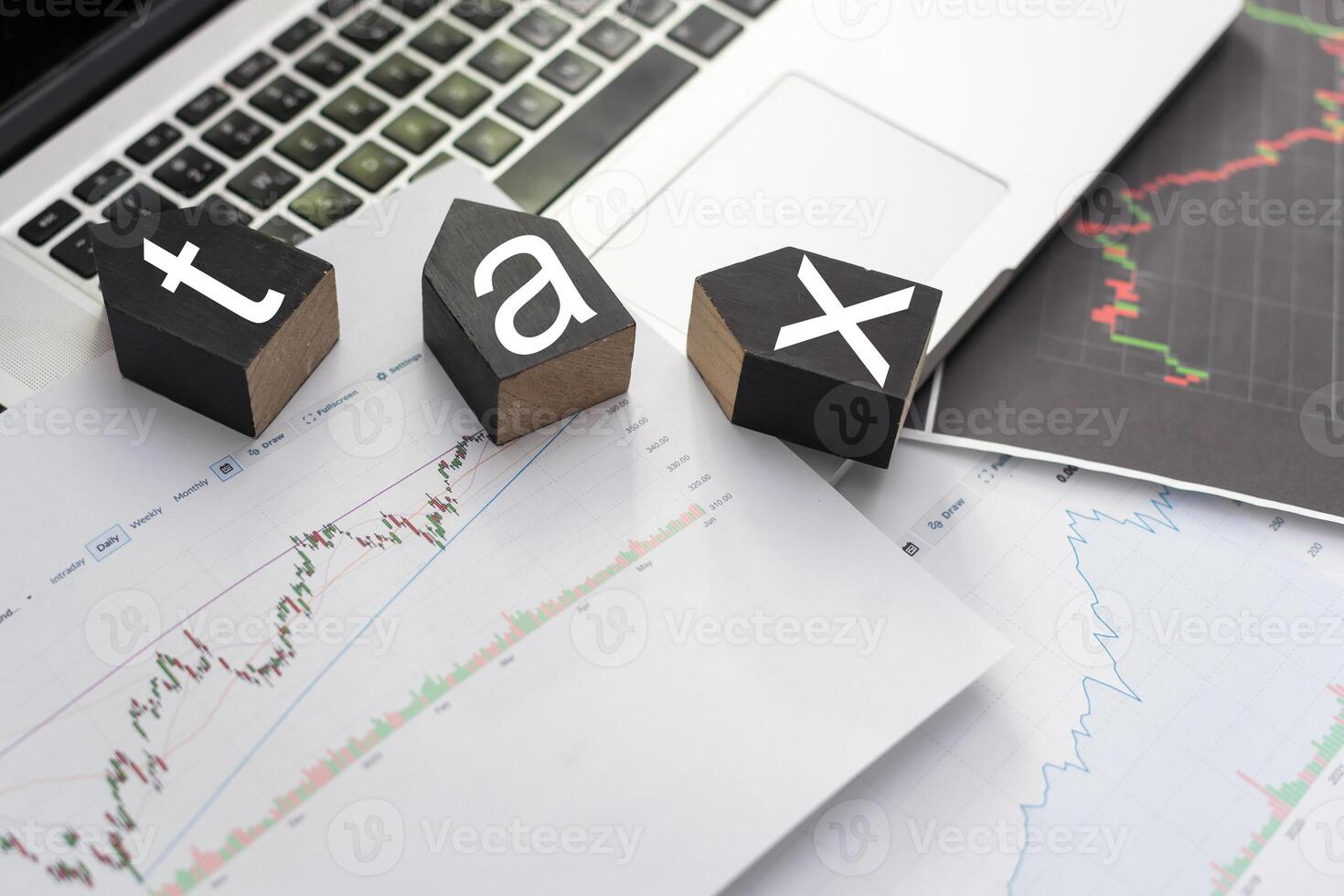 Tax text in wooden cubes and tax or vat form documents to complete Individual income tax return form for payment to Government. Calculation tax return in 2022 to 2023. photo