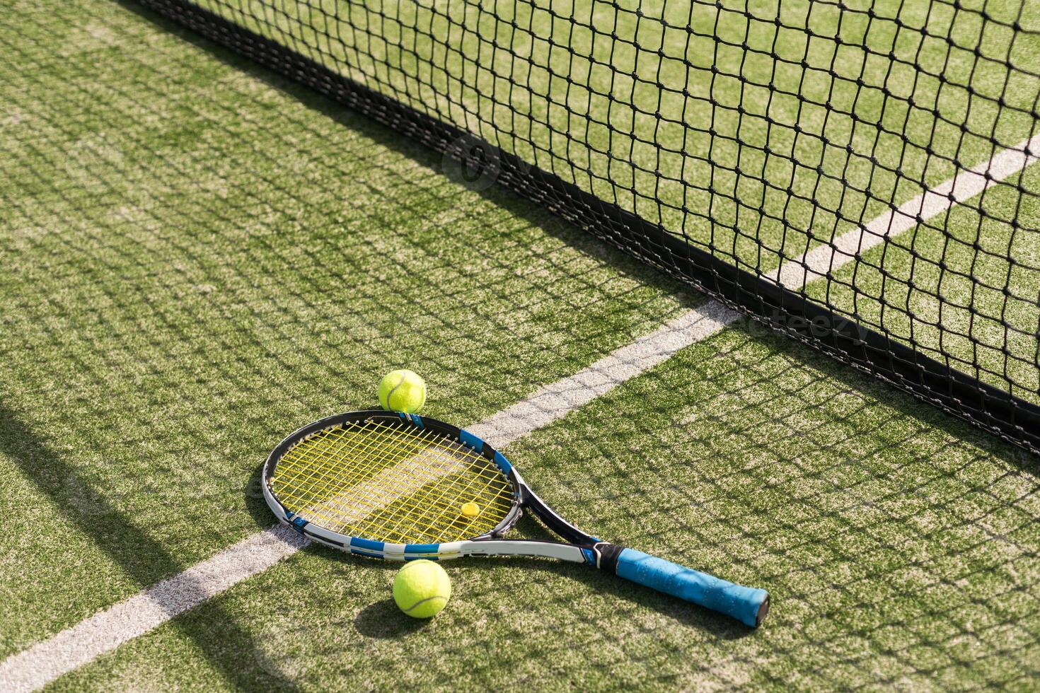 Tennis racket with a set of balls photo