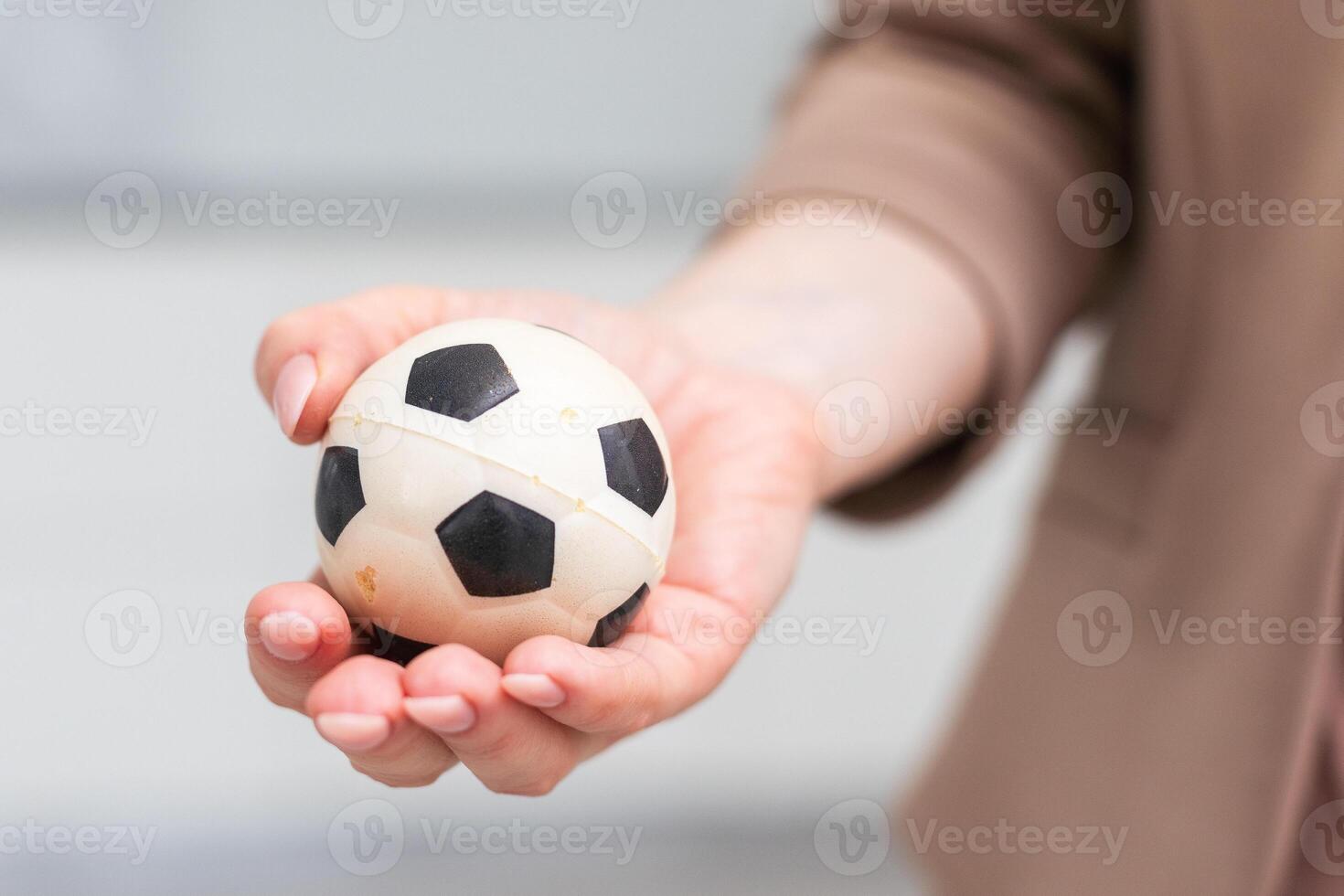 Woman hand with football on white background photo