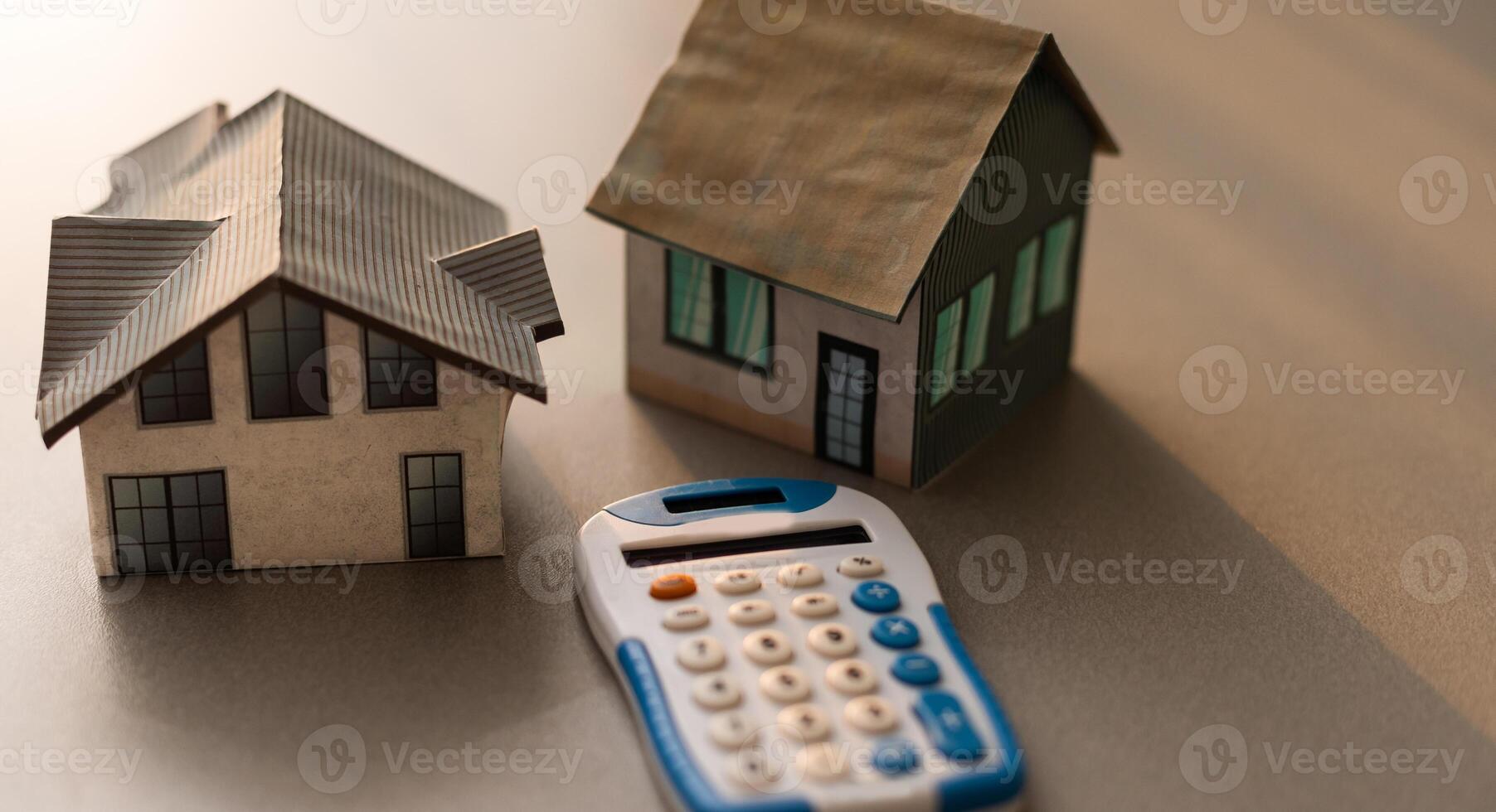 Toy house and calculator on table close-up photo