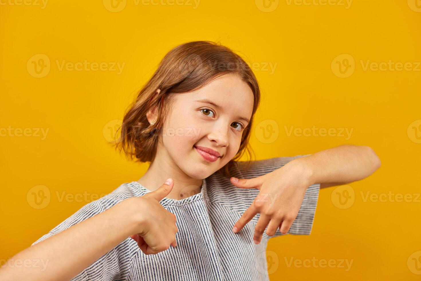 Portrait happy girl teenage, pointing finger on herself photo