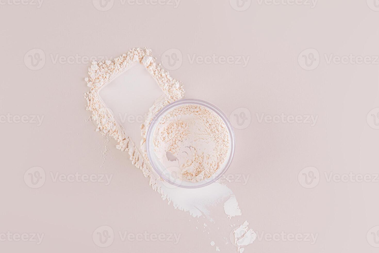 The jar of loose powder in the jar sits on the powder swatch next to the makeup pad. Top view. Delicate matte powder. Easy blending. photo