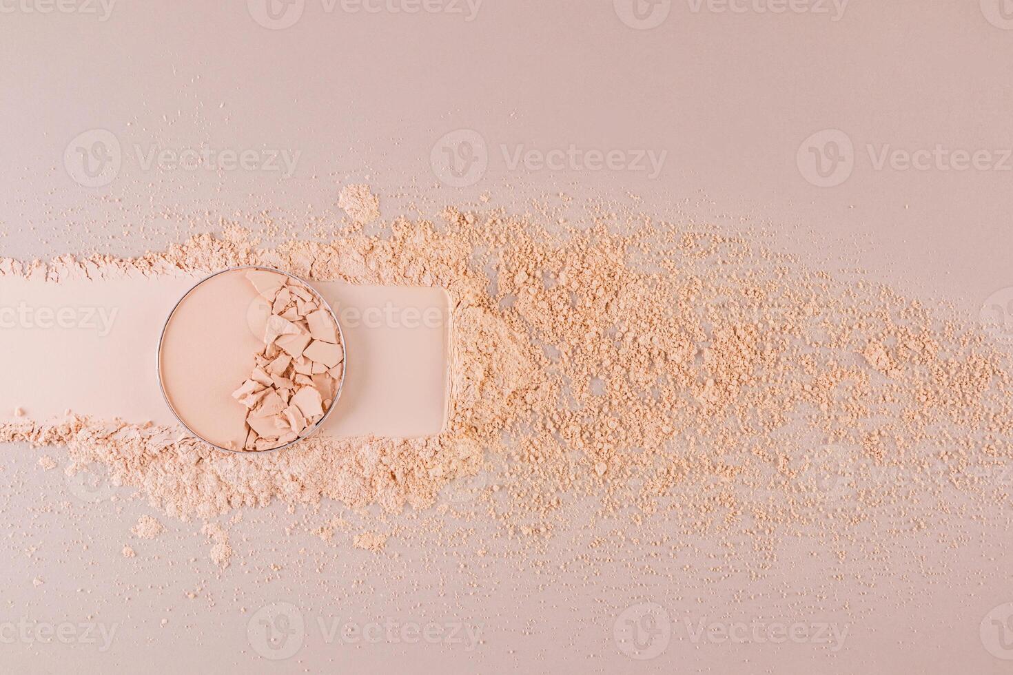 A block of compact powder in a natural tone with the texture of broken pieces stands on a swatch of powder. loose powder. A copy space. top view. photo