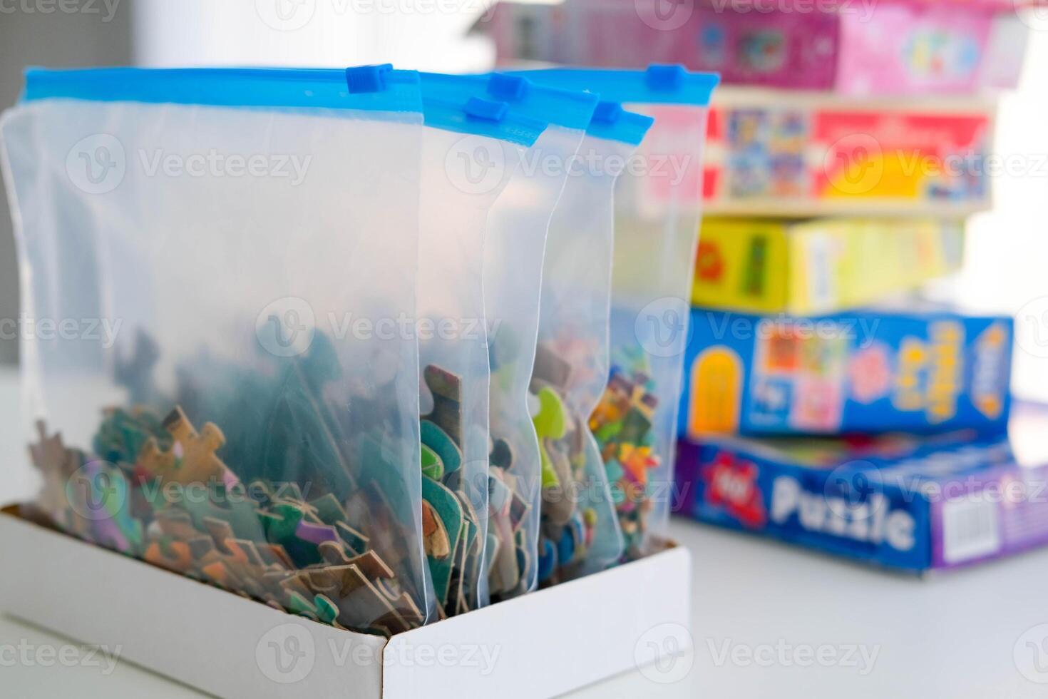 Organization of space and storage of children's board games. Storing puzzles in zip bags. photo