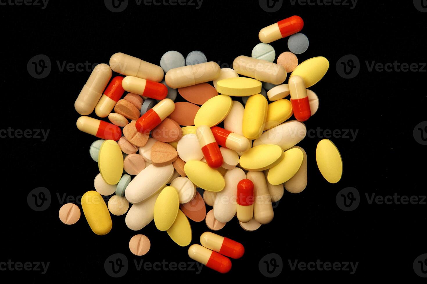 Many different colorful medications and pills. A pile of various multicolored drugs. photo
