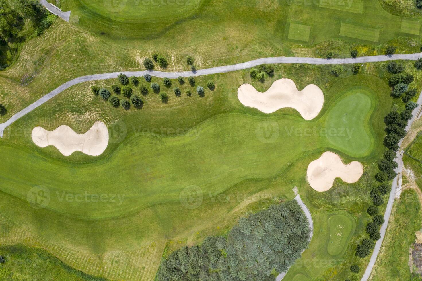 Landscape in a golf course an aerial view of a green field, lawn, and grass. Design for golfers to play games, sports, and outdoor recreation activities. photo