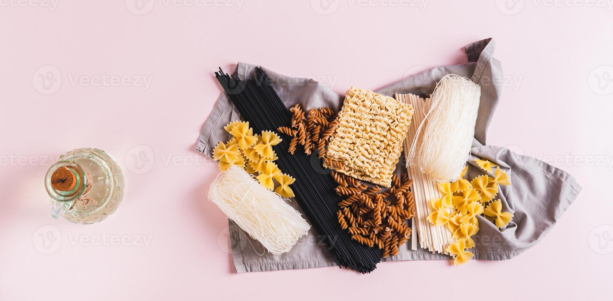 Funchoza, udon, black noodles, buckwheat and wheat pasta on a napkin top view web banner photo