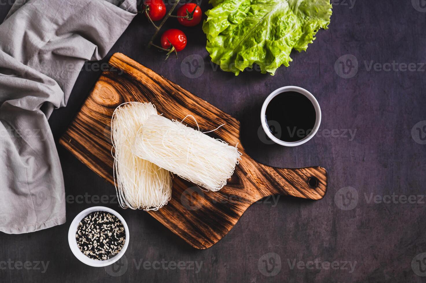 Asian raw rice noodles funchose on a wooden board on the table top view photo