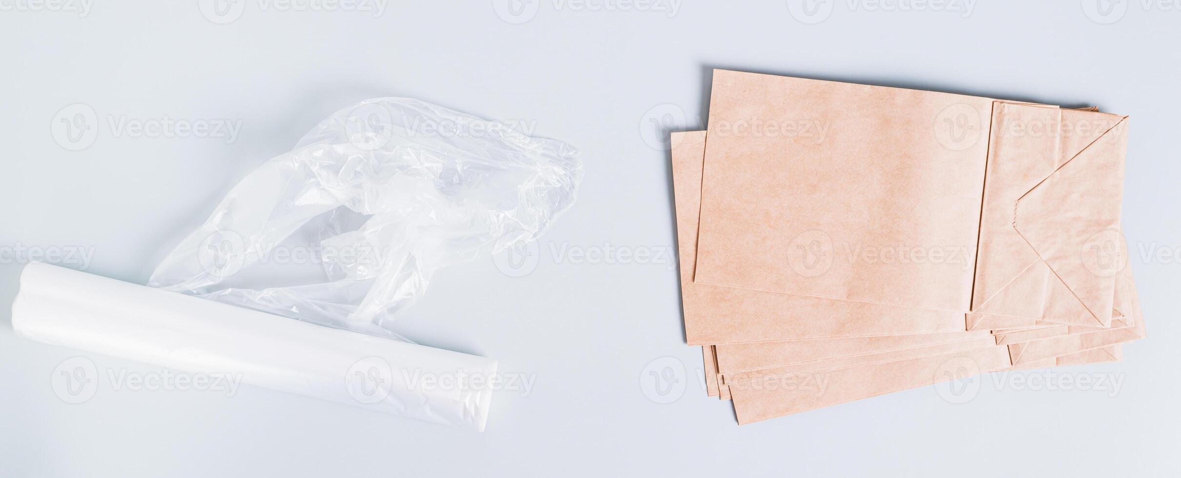 Eco friendly choice between plastic and paper bags on a blue background top view web banner photo