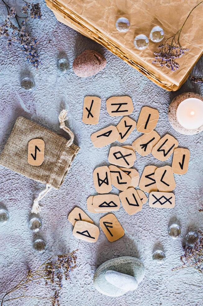 Scandinavian runes for fortune telling made of cardboard on the table top and vertical view photo