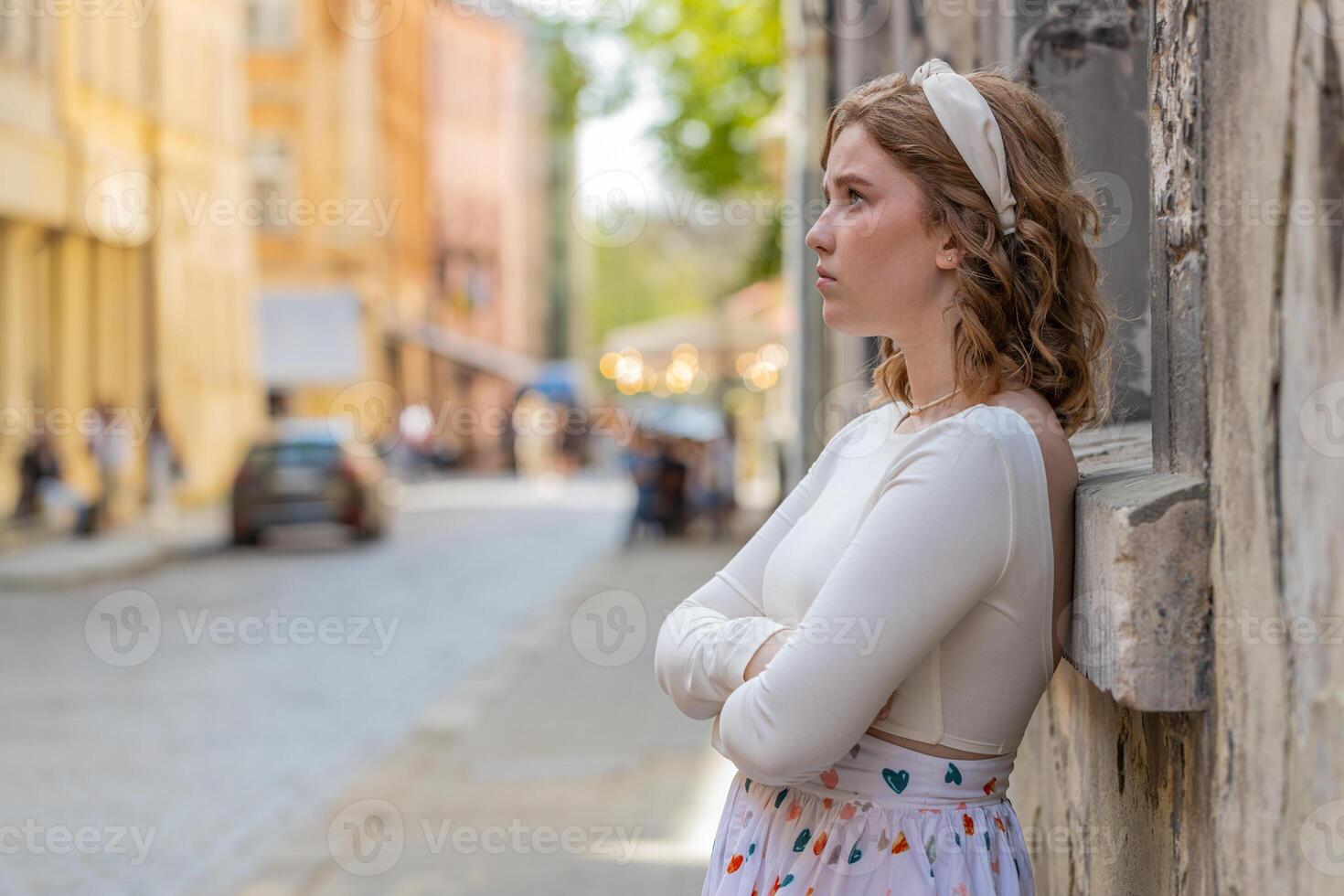 Sad lonely frustrated depressed unhappy woman feeling bad annoyed burnout standing in city street photo